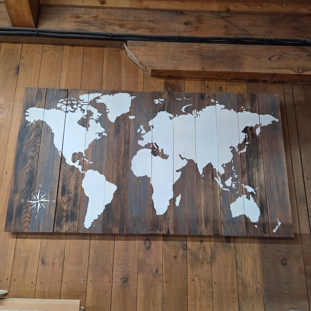 Actual one-off 60 by 34 inch painted wood world map from The Attic, front view